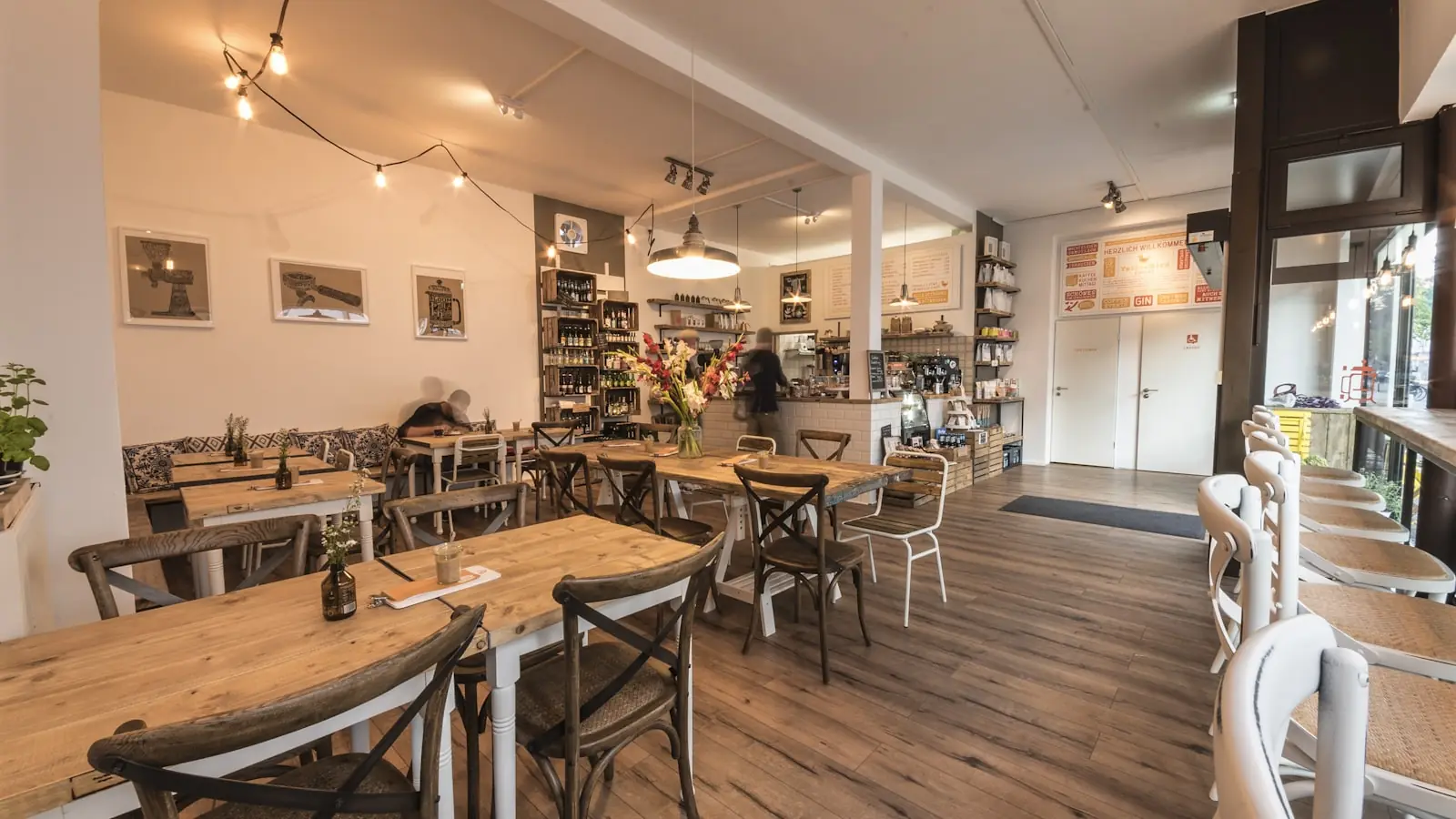 Inside Hawthorn and Vine, warm light, wooden tables, and fresh flowers